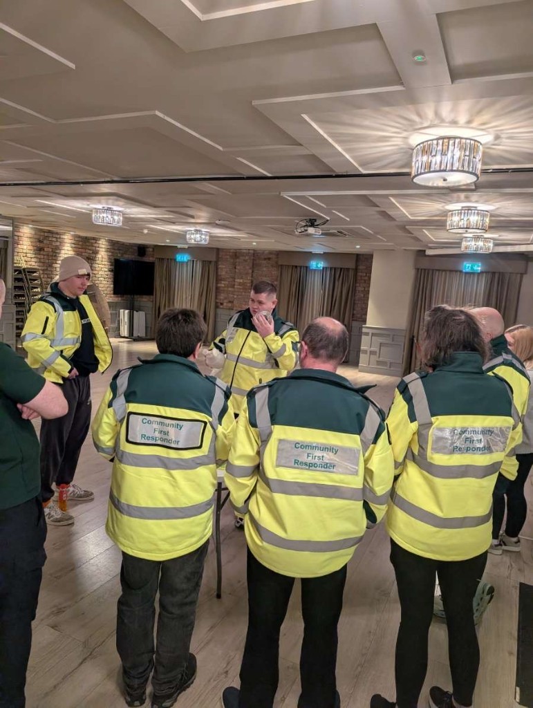 Volunteers with AED at community venue